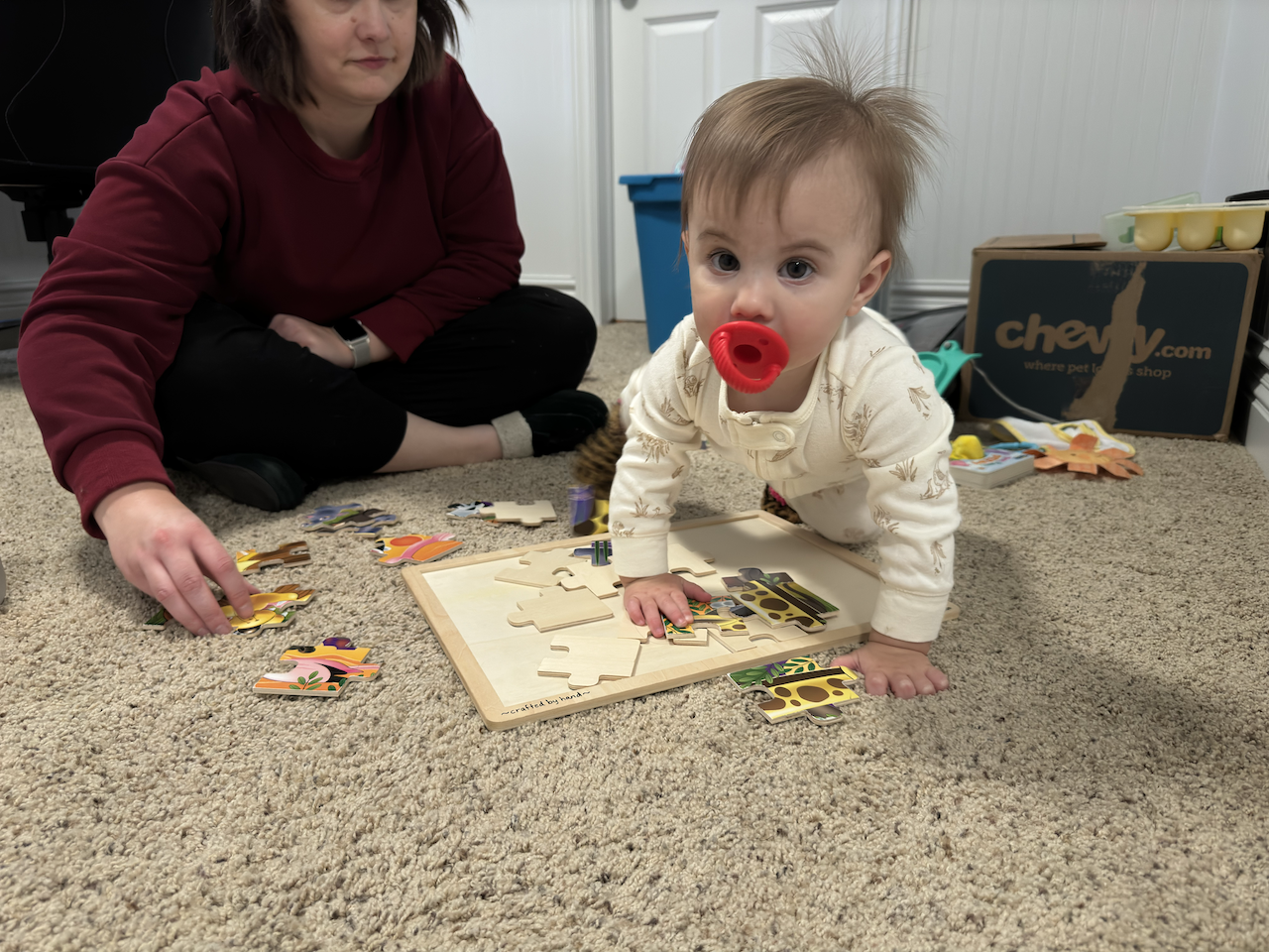 Zoe crawling over mom's puzzel.